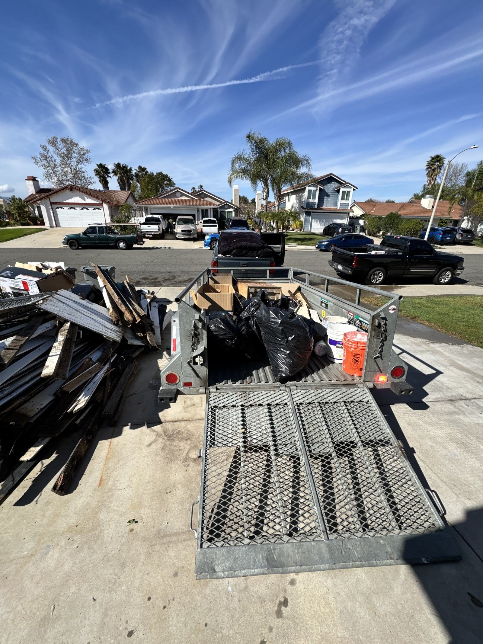 Junk Corral local junk removal crew truck and trailer on a Temecula Valley job
